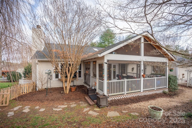 back of house with a sunroom