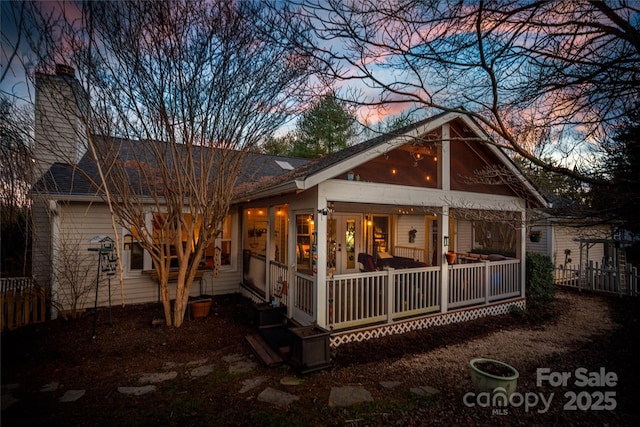 view of back house at dusk