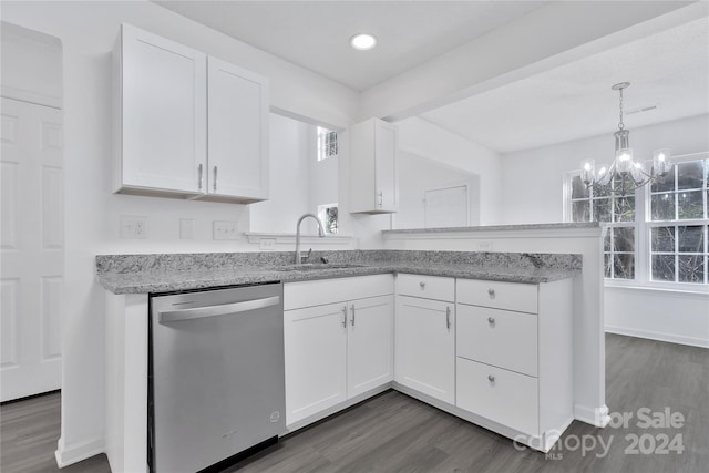 kitchen featuring dark wood-type flooring, sink, stainless steel dishwasher, white cabinetry, and kitchen peninsula