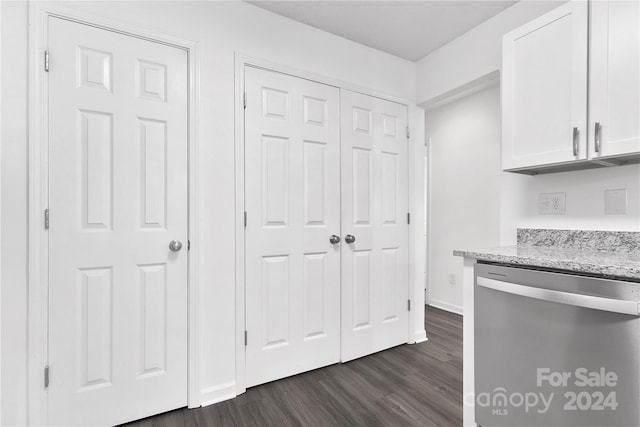 kitchen featuring stainless steel dishwasher, dark hardwood / wood-style floors, light stone counters, and white cabinetry