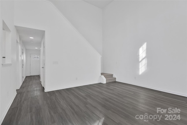 unfurnished room with dark hardwood / wood-style floors