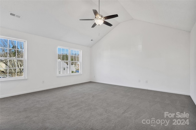 unfurnished room featuring ceiling fan, vaulted ceiling, and dark colored carpet