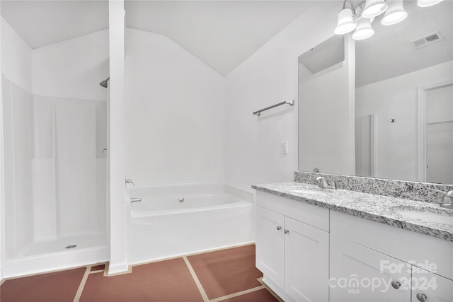 bathroom with plus walk in shower, vanity, and vaulted ceiling