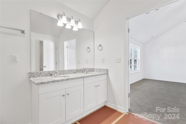 bathroom with vanity and vaulted ceiling