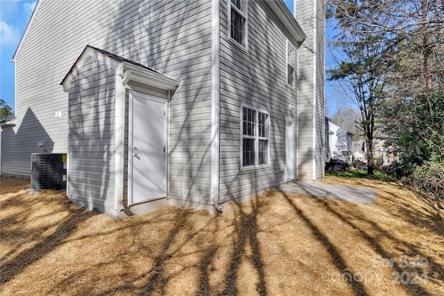 view of side of home featuring central AC unit