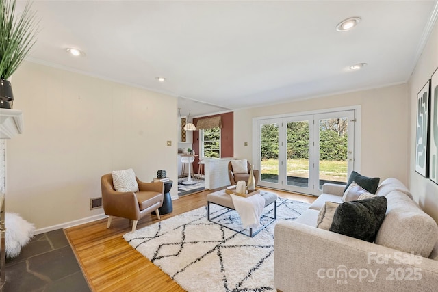 living room featuring wood-type flooring and crown molding