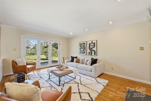 living room featuring light hardwood / wood-style flooring and ornamental molding