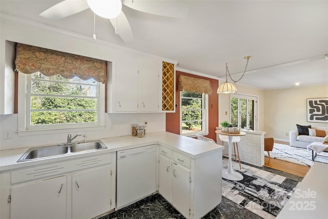 kitchen featuring hanging light fixtures, white cabinets, sink, and white dishwasher