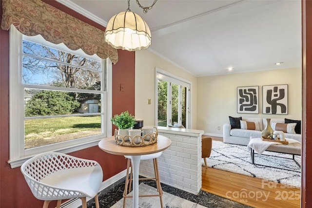 dining room featuring hardwood / wood-style flooring and crown molding