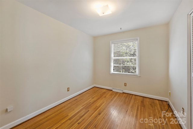 spare room featuring hardwood / wood-style flooring