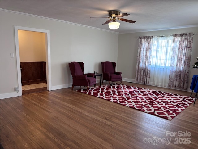 sitting room featuring crown molding, wood-type flooring, and ceiling fan