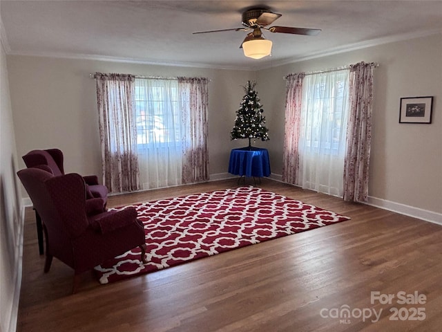 unfurnished room featuring ceiling fan, a wealth of natural light, ornamental molding, and wood-type flooring