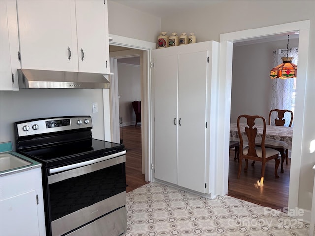 kitchen featuring stainless steel range with electric cooktop and white cabinets