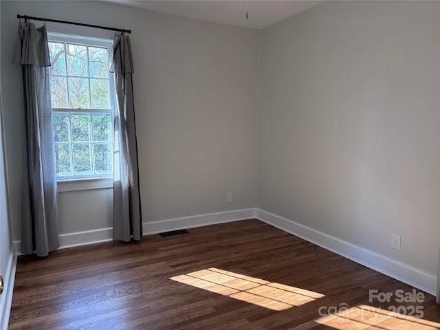 unfurnished room featuring dark hardwood / wood-style floors