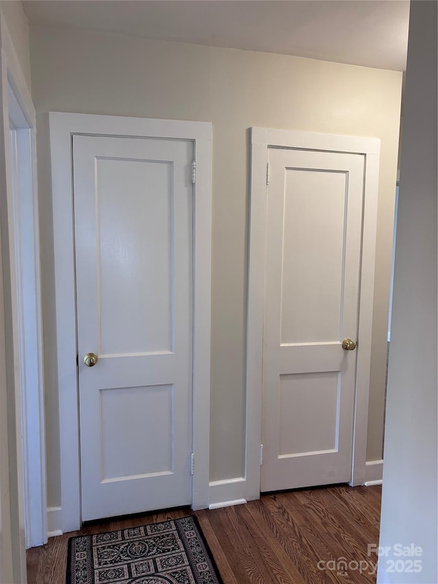 hallway with dark hardwood / wood-style flooring