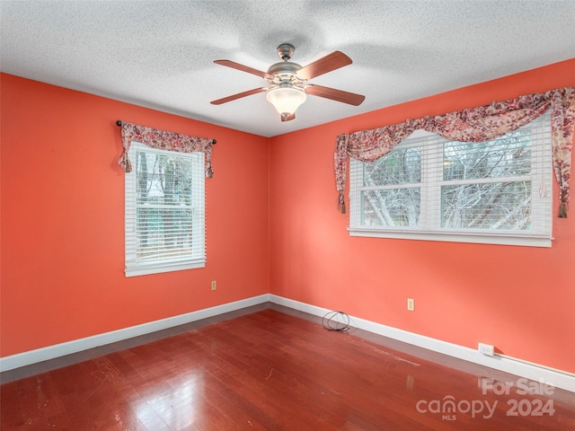 unfurnished room with a textured ceiling, hardwood / wood-style flooring, and ceiling fan