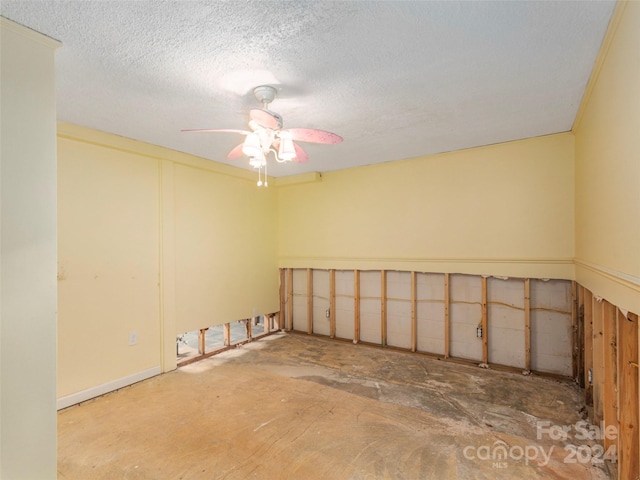 unfurnished room featuring ceiling fan, concrete floors, and a textured ceiling