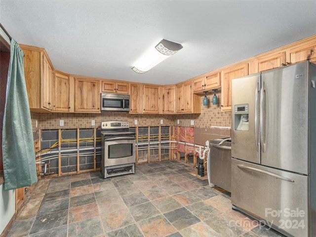 kitchen featuring decorative backsplash and appliances with stainless steel finishes