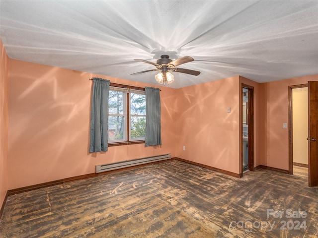 spare room with ceiling fan and a baseboard heating unit