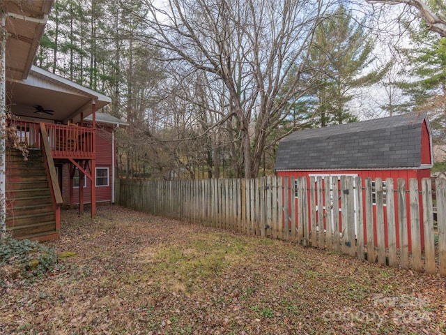 view of yard with a shed and a wooden deck