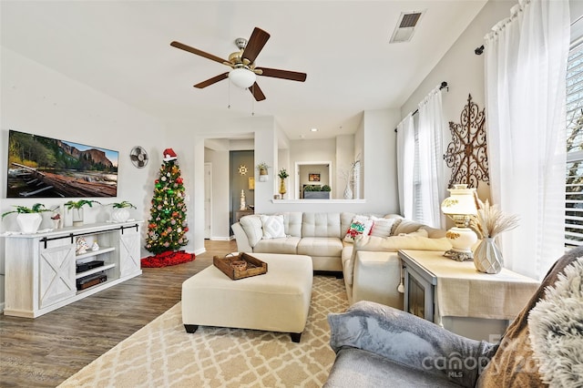 living room featuring hardwood / wood-style floors and ceiling fan