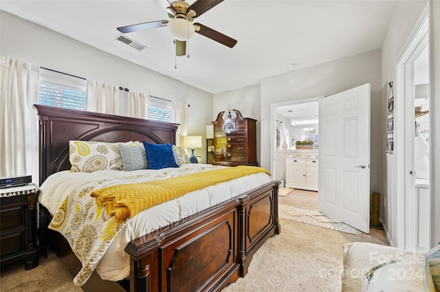 carpeted bedroom featuring connected bathroom and ceiling fan