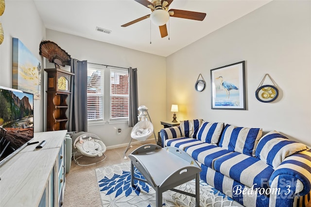 carpeted living room with ceiling fan