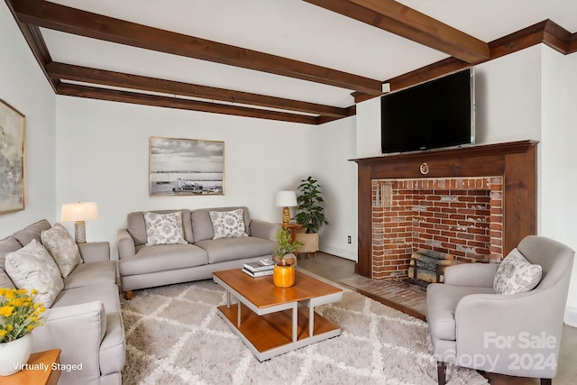 living room featuring beamed ceiling and a fireplace