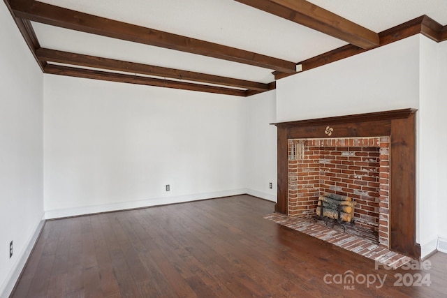 unfurnished living room with a fireplace, beam ceiling, and dark wood-type flooring