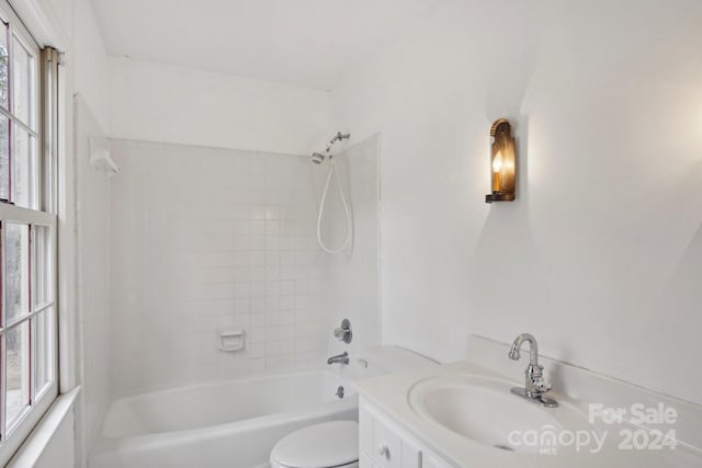 full bathroom with vanity, toilet, and tiled shower / bath combo