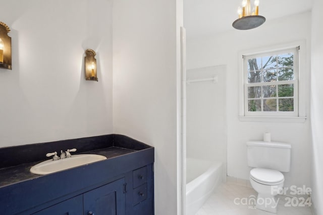 bathroom featuring tile patterned floors, vanity, and toilet