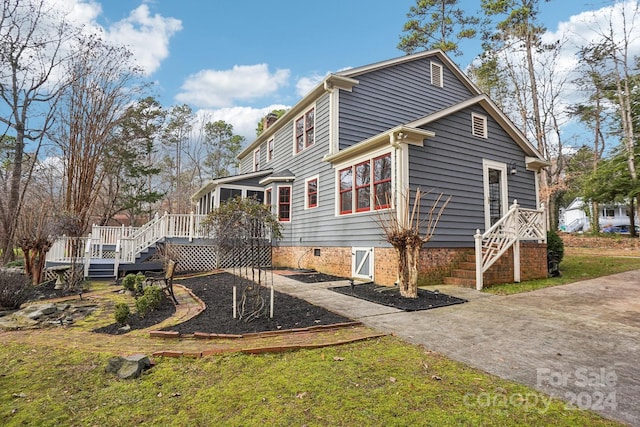 exterior space featuring a sunroom and a yard