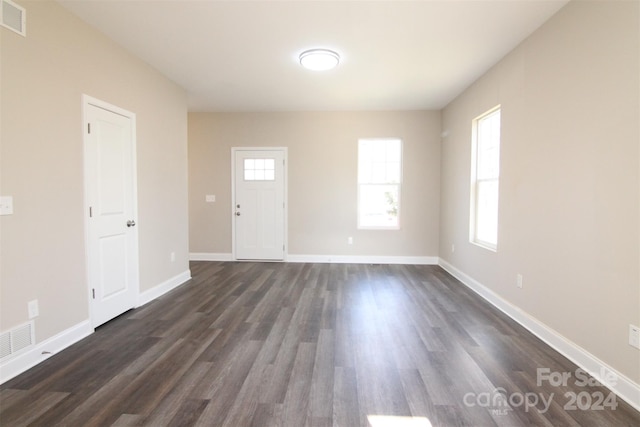 spare room featuring dark wood-type flooring