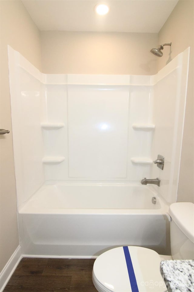 bathroom featuring shower / bath combination, hardwood / wood-style flooring, and toilet