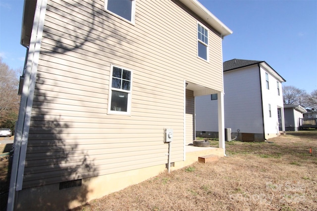 view of side of property with a lawn