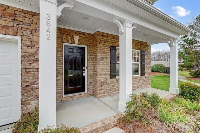 view of exterior entry with a porch