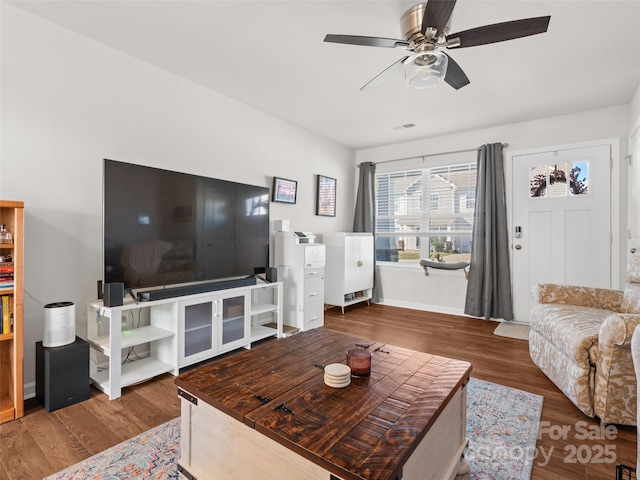 living room featuring hardwood / wood-style flooring and ceiling fan