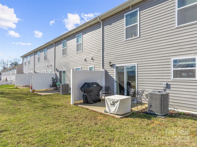 rear view of property with a patio, central AC, and a lawn