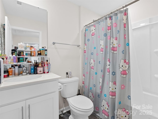 bathroom featuring vanity, toilet, and curtained shower