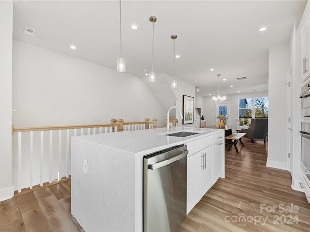 kitchen with a center island with sink, white cabinets, and stainless steel dishwasher