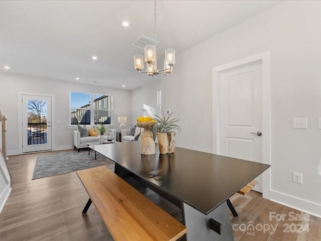 dining area with a chandelier and hardwood / wood-style floors