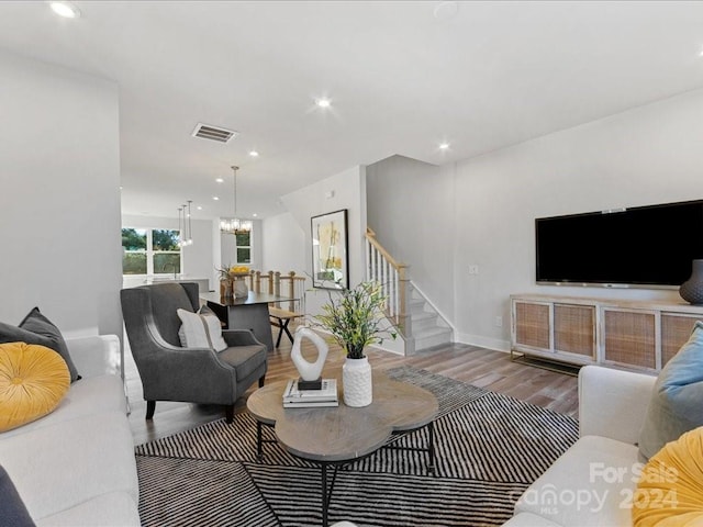 living room with a chandelier and wood-type flooring