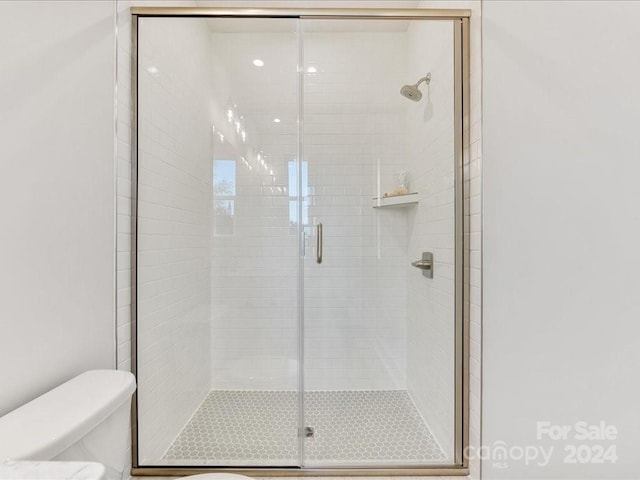 bathroom with toilet and walk in shower