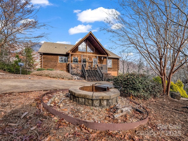 back of property with an outdoor fire pit