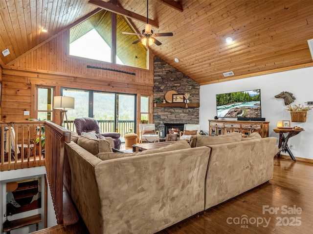 living room with ceiling fan, dark wood-type flooring, a stone fireplace, high vaulted ceiling, and wood ceiling