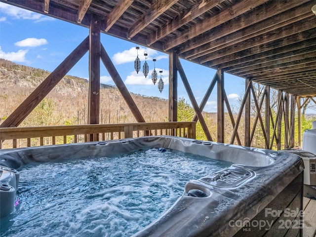 wooden deck with a hot tub