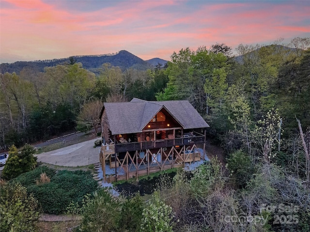 aerial view at dusk with a view of trees
