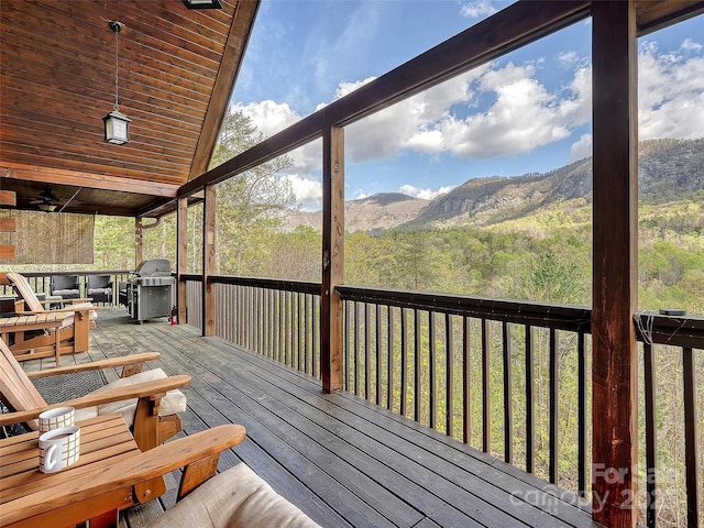 wooden terrace featuring grilling area and a mountain view