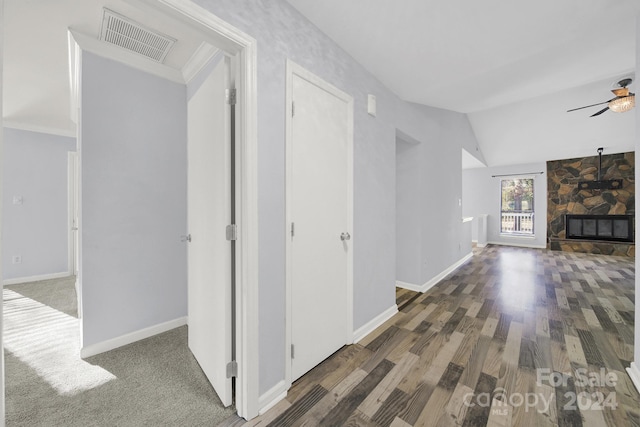 hall featuring dark hardwood / wood-style floors and vaulted ceiling