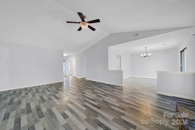 unfurnished living room with ceiling fan with notable chandelier, hardwood / wood-style flooring, and vaulted ceiling